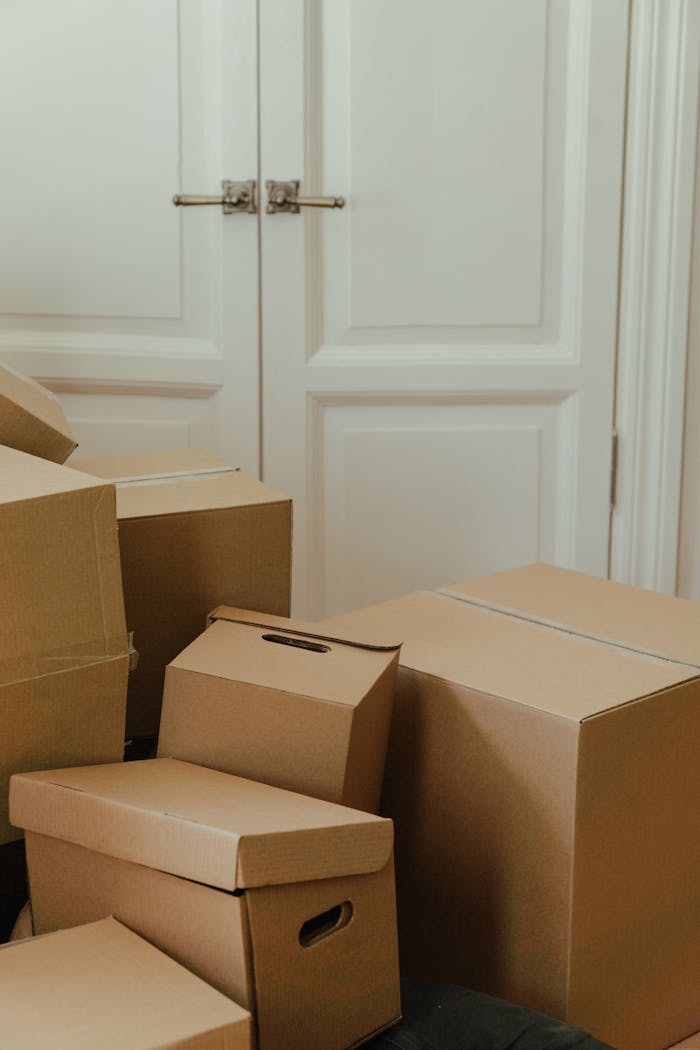 Cardboard boxes stacked in an apartment, signifying a move-in or relocation process.